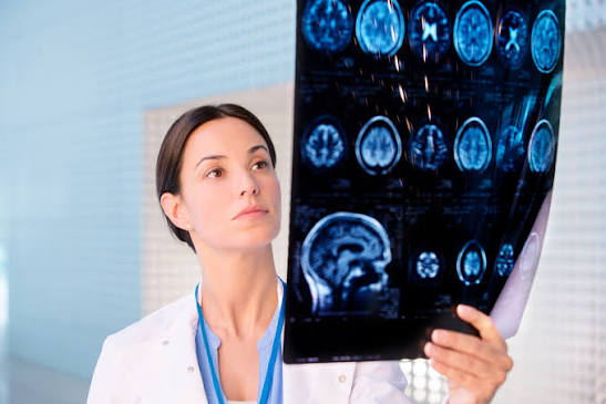 Clinician examining a brain MRI film