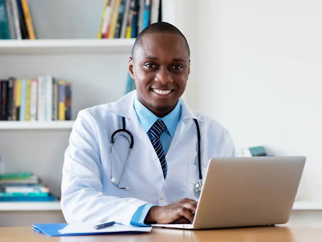Clinician working at a laptop in an office