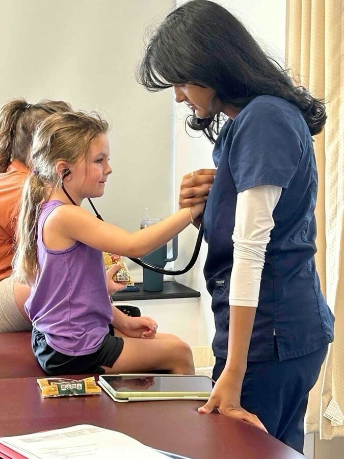 Clinician examining a young patient