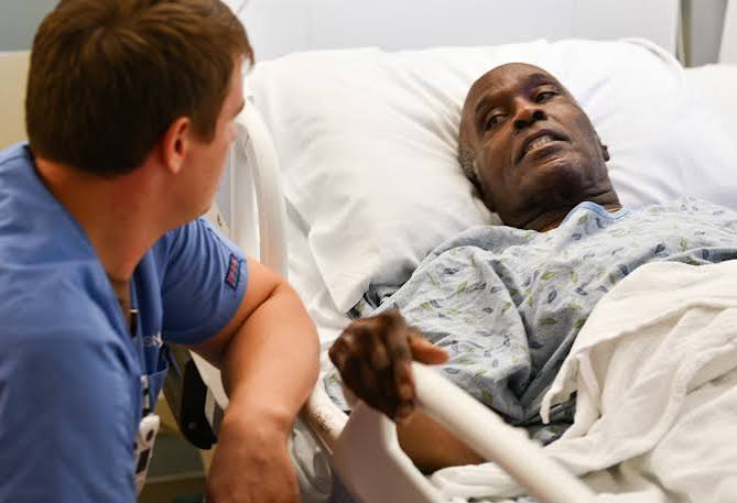 Nurse comforting a patient at the bedside