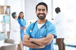 Nurse smiling with colleagues in a hallway