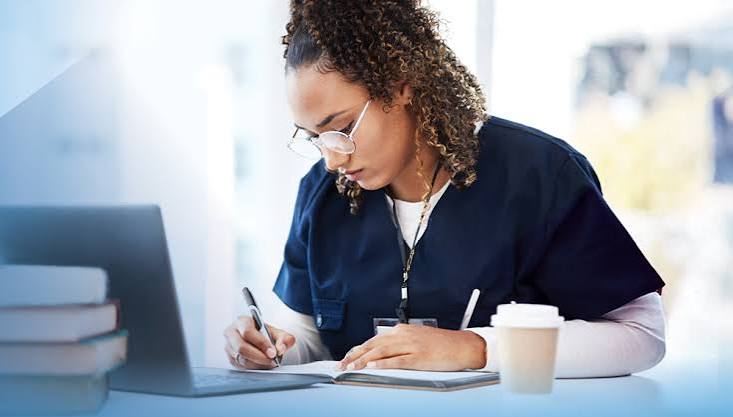 Student studying at a desk with coffee and notebook